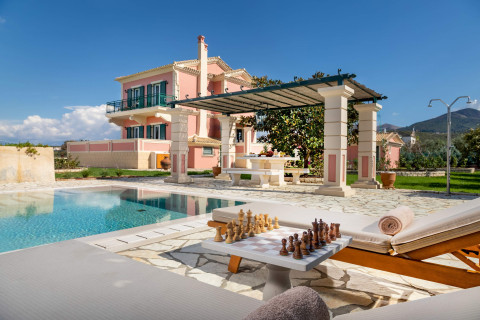 Pool area with pergola and chess board overlooking mountain views