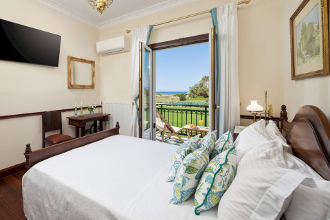 Master bedroom with sea view balcony and elegant furnishings